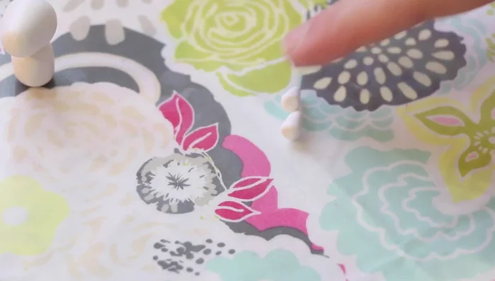 Add legs: Roll out teardrop shapes for the back legs, flatten the bottom, and attach them to the body. Use smaller balls for the front legs, attaching and blending them in.