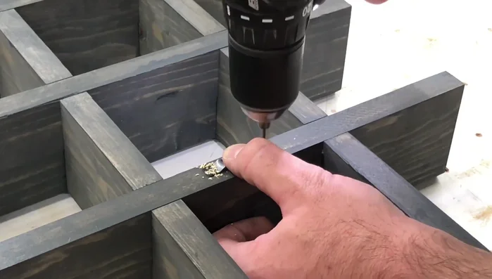 Attach sawtooth hangers to the back of the shelf using 3/4 inch wood screws.