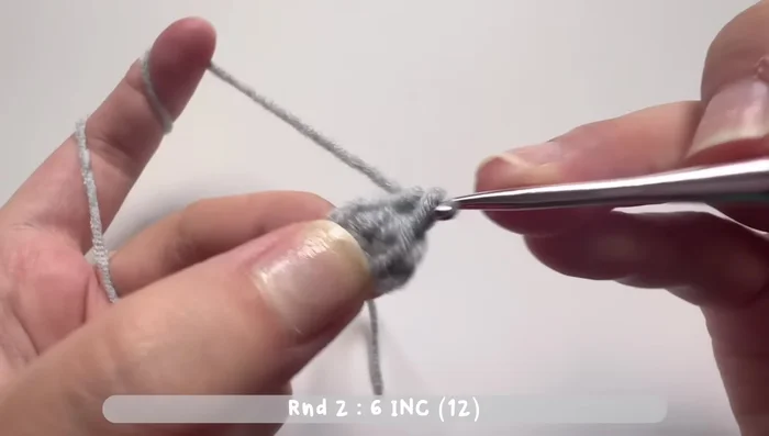 Round 3: Increase stitch (two single crochets in one stitch) after one single crochet. Repeat six times. Total of 18 single crochets.