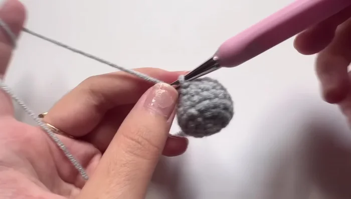 Round 8: One single crochet, one single crochet, one increase stitch. Repeat six times. Total of 24 stitches.