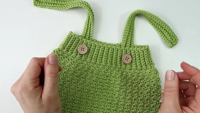 Sew buttons onto the front of the romper.