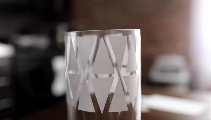 Place the paper masks onto the vase where you want the clear glass to show through.
