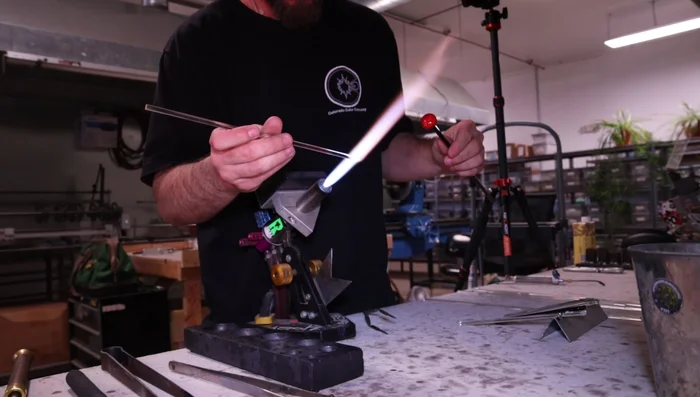 Melt and smooth the loop, ensuring it is wide enough for a cord.