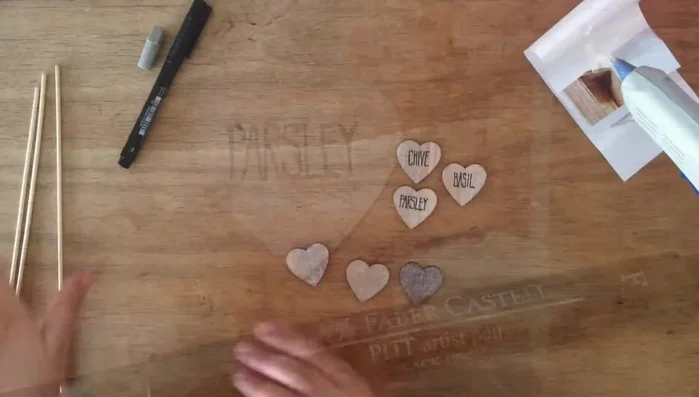 Write the herb names neatly on the hearts using your artist pen.