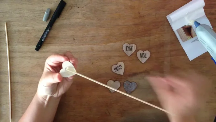 Hold the stick in place until the glue dries to ensure proper adhesion.