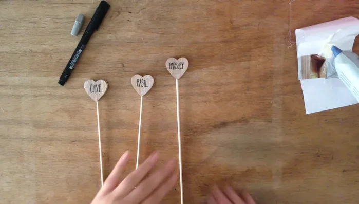 Repeat steps 4-6 for each wooden heart and herb name.