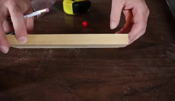 Drill a hole using a Forstner bit (1.25 to 1.625 inches in diameter) at the marked center point.