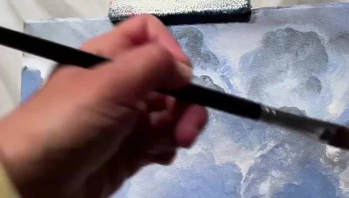 Create a sunray effect by brushing back and forth, then using the tip of the brush for thin, narrow lines. Add smaller half-circles with white for added depth.