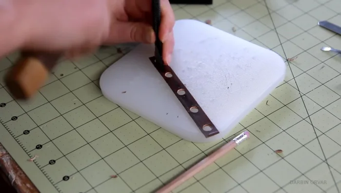 Mark and punch stitching holes on wider strip between magnets.