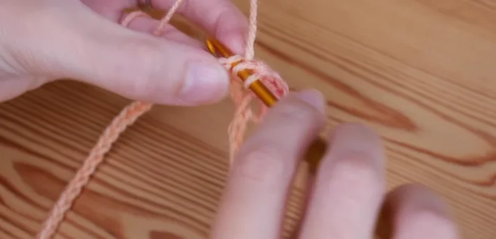 Repeat steps 3 and 4 across the row, ending with a single treble crochet in the last chain.