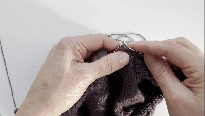 Continue ribbing, performing the centered decrease at the end of each round until the desired v-neck depth is achieved.