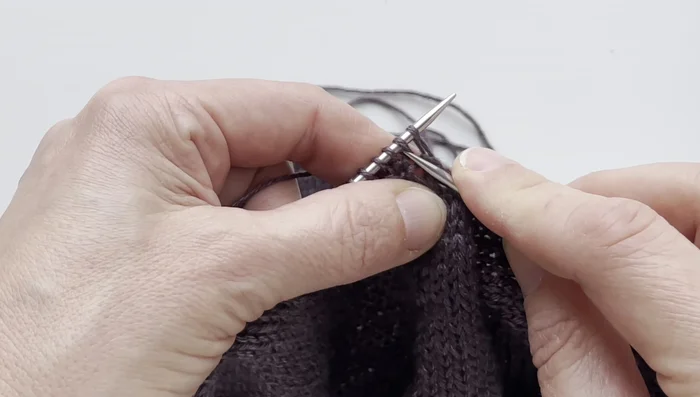 Continue ribbing, performing the centered decrease at the end of each round until the desired v-neck depth is achieved.