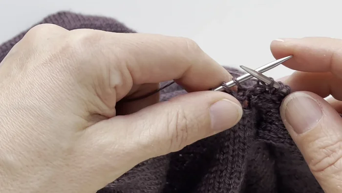 Continue ribbing, performing the centered decrease at the end of each round until the desired v-neck depth is achieved.