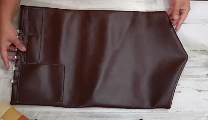 Turn the clutch right side out. Measure down 4 inches (or your desired height for the flap) from the top and fold down. Use the fold as a guide for placing the male part of the magnetic snap.