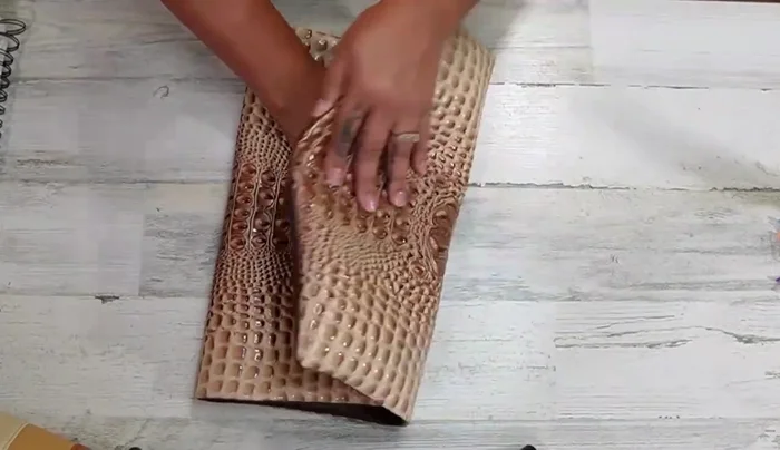 Turn the clutch right side out. Measure down 4 inches (or your desired height for the flap) from the top and fold down. Use the fold as a guide for placing the male part of the magnetic snap.