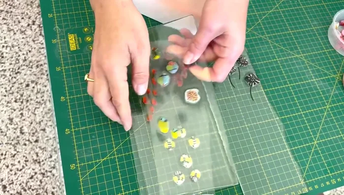 Embed marine life: Carefully place marine life embellishments (fish, shells, anemones) into the glass layers.