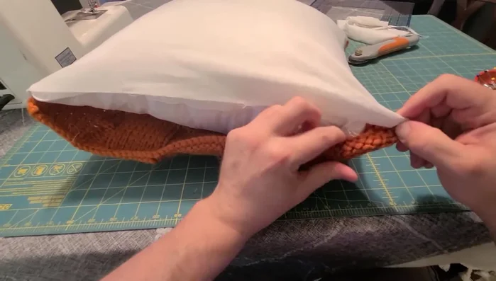 Hand-stitch the open end closed, using a needle and thread matching the backing fabric.