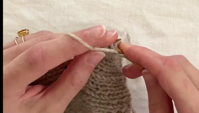 Complete button band: Continue double knitting until you've worked to the end of the picked-up stitches, joining the last stitch with the first using a Kitchener stitch.