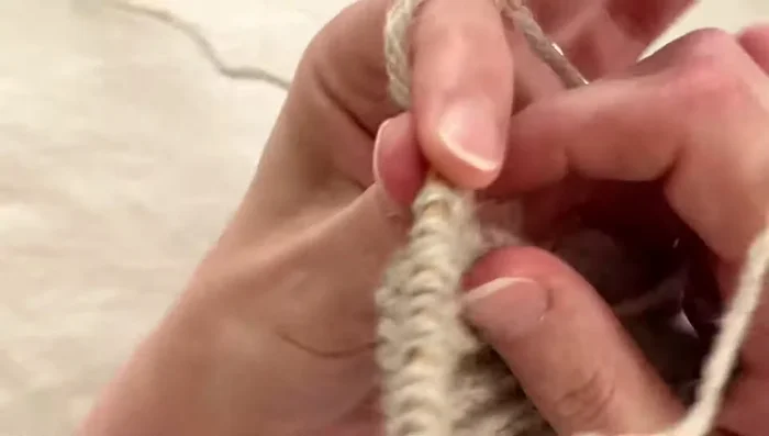 Join button band to cardigan: Knit two stitches together through the back loop to join the cast-on stitches to the picked-up stitches.