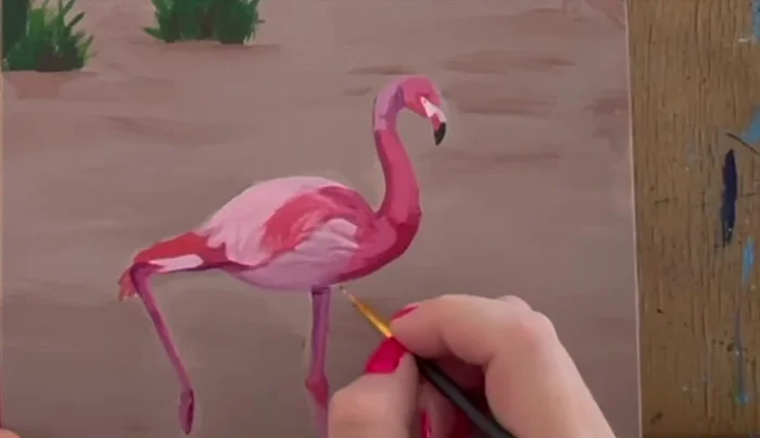 Use a medium purple wash to carefully outline the flamingo.