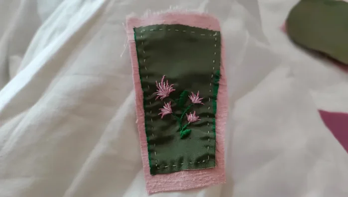 Press a quarter inch seam allowance into the top of each pocket, and press the bottom up.