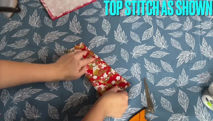 Attach the Pocket: Turn the pocket piece inside out, iron flat. Attach the pocket to the main wallet piece by sewing along the top edge.