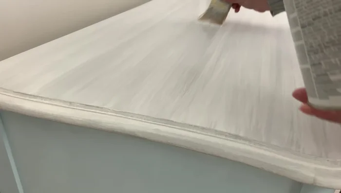 Clean and paint dresser hardware with Rust-Oleum Metallic Silver paint, and seal with a water-based polyurethane spray.