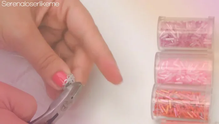 Add a small cap and cut excess wire. Create another hook at the end of the wire. Add a jump ring, then the clasp, and close the jump ring.