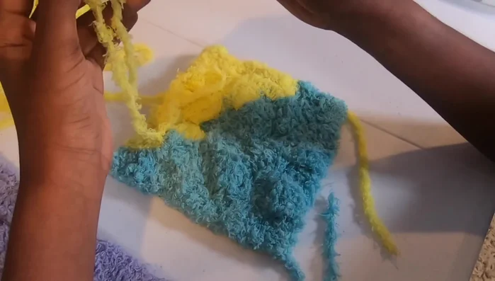 Single crochet border: Create a slip knot, join to the first gap, chain 1, work 3 single crochets, then move to the next gap, working 2 single crochets in gaps along the edge.