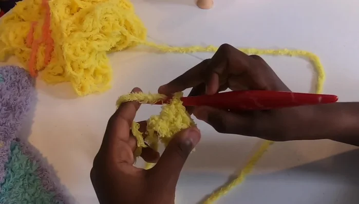 Repeat step 6, increasing the number of blocks in each row until your blanket reaches your desired width (approximately 37 inches in the video).