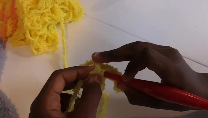 Repeat step 6, increasing the number of blocks in each row until your blanket reaches your desired width (approximately 37 inches in the video).