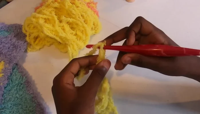 Repeat step 6, increasing the number of blocks in each row until your blanket reaches your desired width (approximately 37 inches in the video).