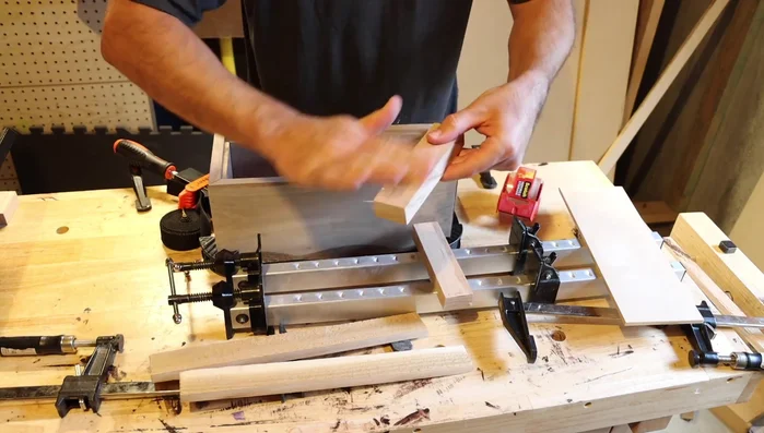 Apply packing tape to the bottom's cleats to prevent glue adhesion during the glue-up.