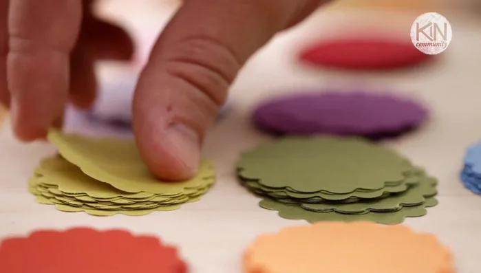 Add paper shapes: Pair up your shapes in sets of two and feed them through the sewing machine, sewing a straight line down the middle. Leave a couple of stitches between each set for movement.