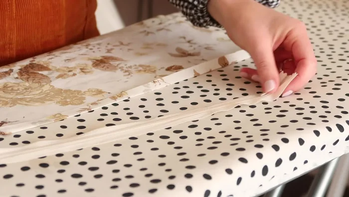 Attach the zipper to the larger rectangle. Fold one long edge, place folded edge against zipper teeth, and stitch in place using a zipper foot.