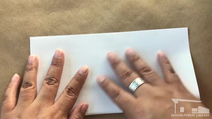 Line up the unfolded corner with the 'X' and crease.