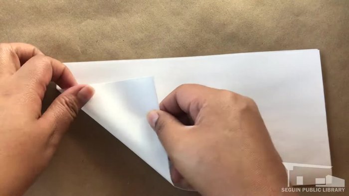 Line up the unfolded corner with the 'X' and crease.