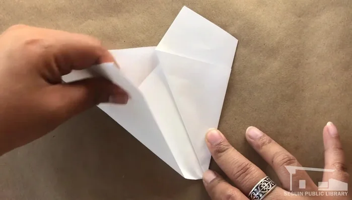 Fold the bottom edge of the other side to match the last fold and crease.