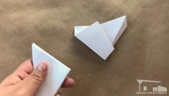 Cut along the front edge of the three large panels to form a pentagon.