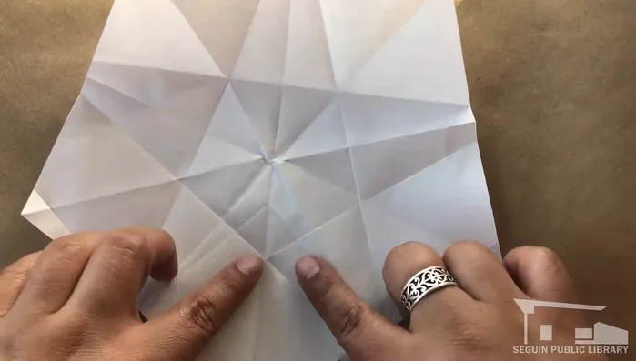 Repeat step 12 on each remaining point, folding clockwise.