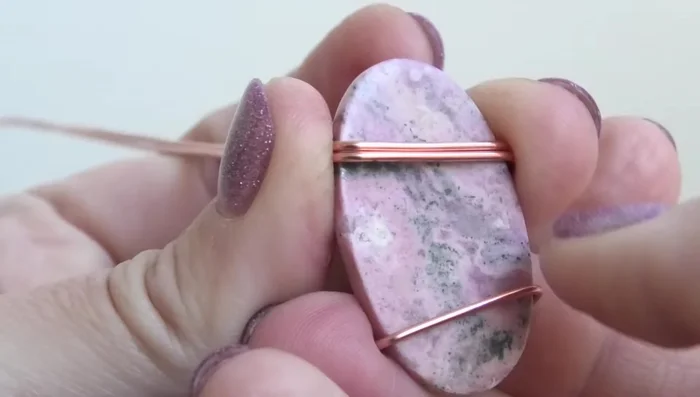 Bend the wires onto the front again. This helps trap the stone more securely.