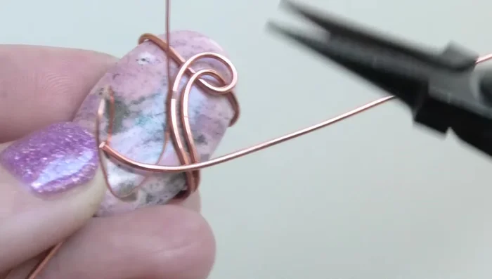 If necessary, attach a new piece of thin wire to create a longer length for wrapping around the bail.