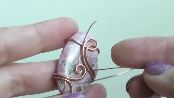 Wrap the remaining thin wire around the two main wires to create a secure connection. Trim and tuck away the excess.