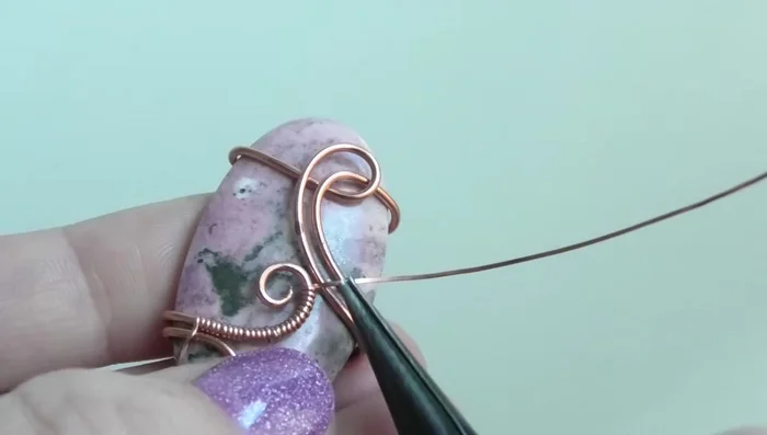 Wrap the remaining thin wire around the two main wires to create a secure connection. Trim and tuck away the excess.