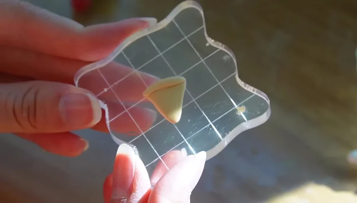 Create the pizza crust using light beige and pale yellow clay, shaping and texturing it.