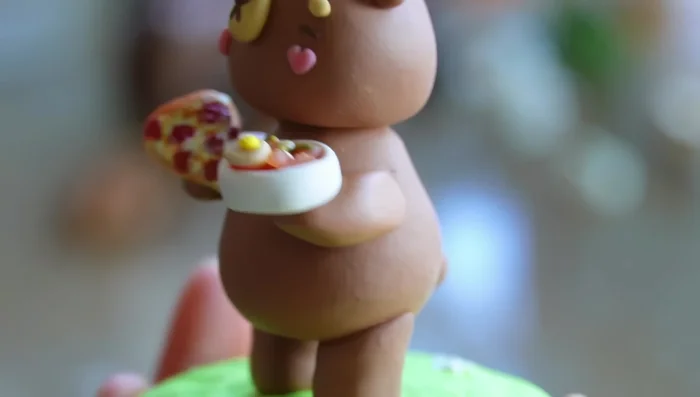 Add arms and flowers using polymer clay. Bake again.