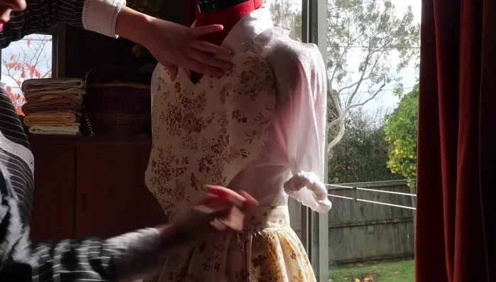 Create ruffles for the heart pocket, similar to the bodice ruffles, and attach to the pocket.