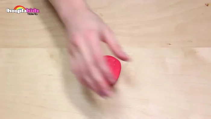 Make watermelon: Roll out pink Play-Doh into a triangle shape. Mix white, light green, and dark green Play-Doh for a marbled rind effect. Attach the rind to the pink section, then add black pips with black Play-Doh.