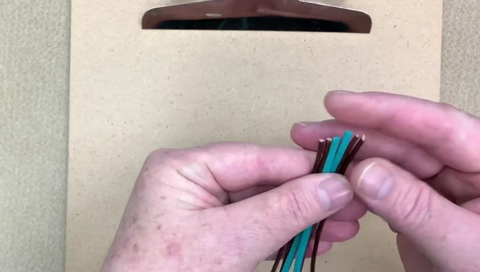 Line up leather and suede pieces, overlapping slightly. Tape the last inch to secure.