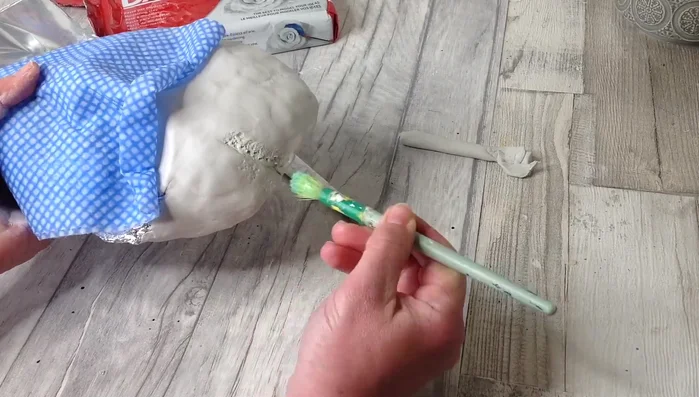 Add texture using various tools such as a paintbrush, old toothbrush, or even scrunched-up tin foil to create a unique effect. A slightly dampened brush helps smooth out the clay.